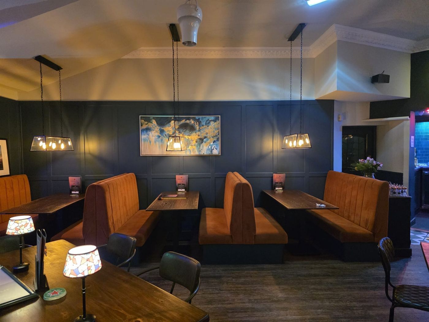 The dining room at Red House Farm, with booth seating and pendant lights