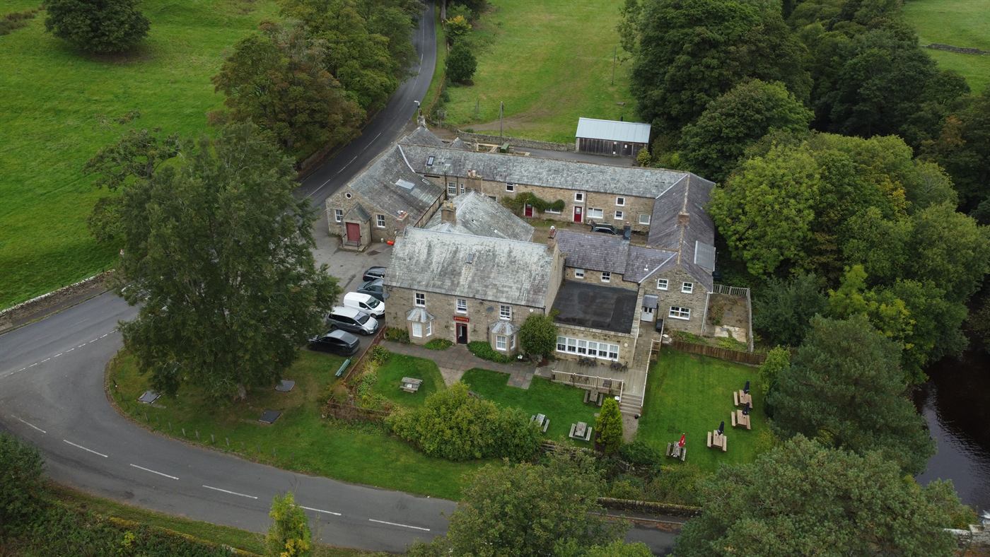 Aerial view of The Elks Head in Whitfield, with its beer garden and the surrounding Northumberland countryside