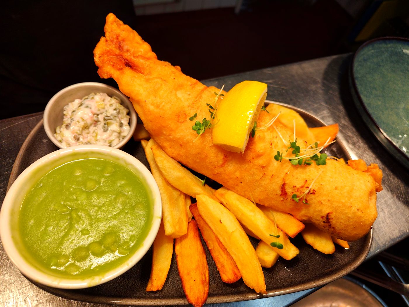 Hand-battered cod and chips with mushy peas and tartare sauce