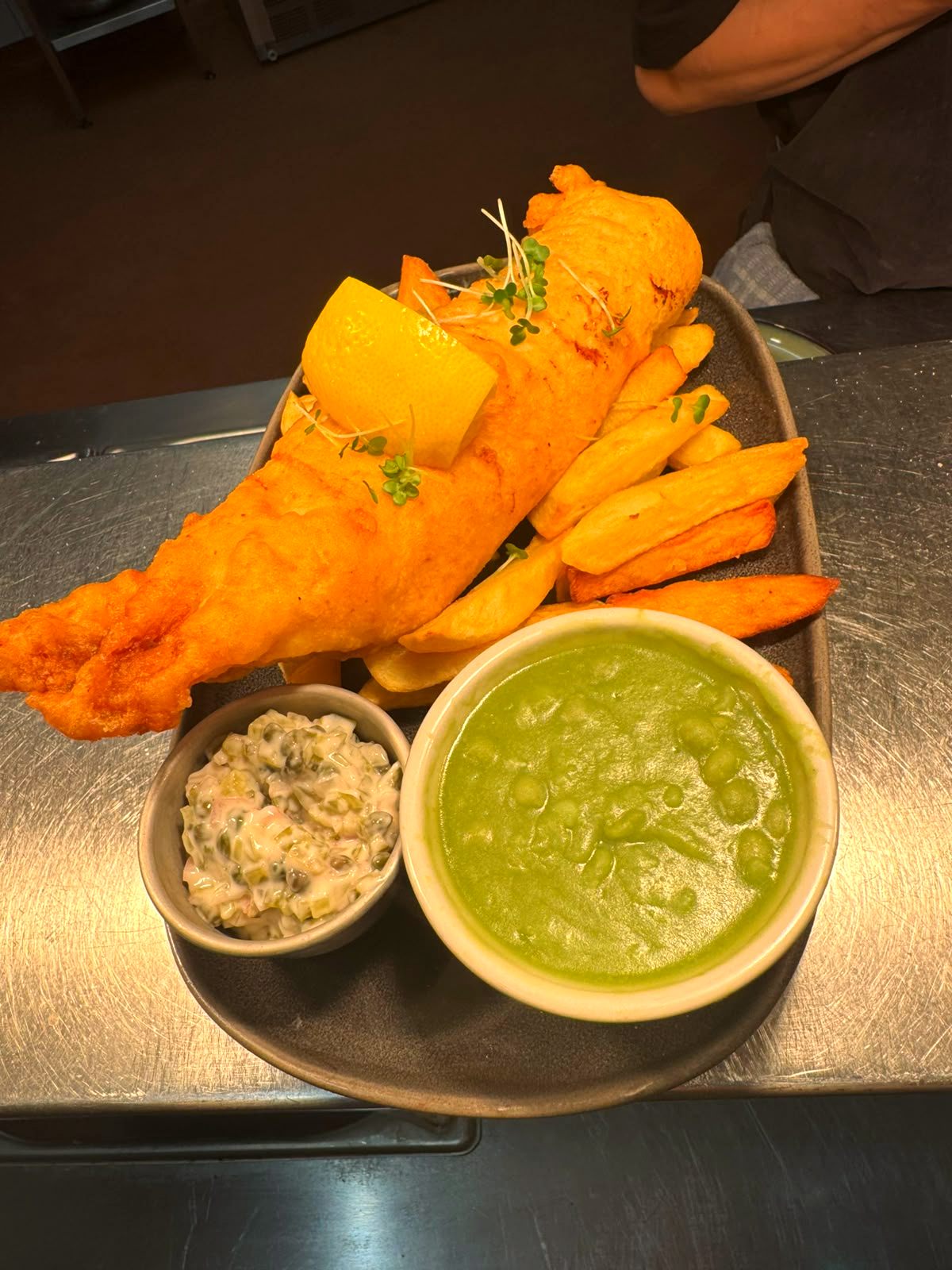 Hand-battered cod with triple-cooked chips, mushy peas and tartare sauce